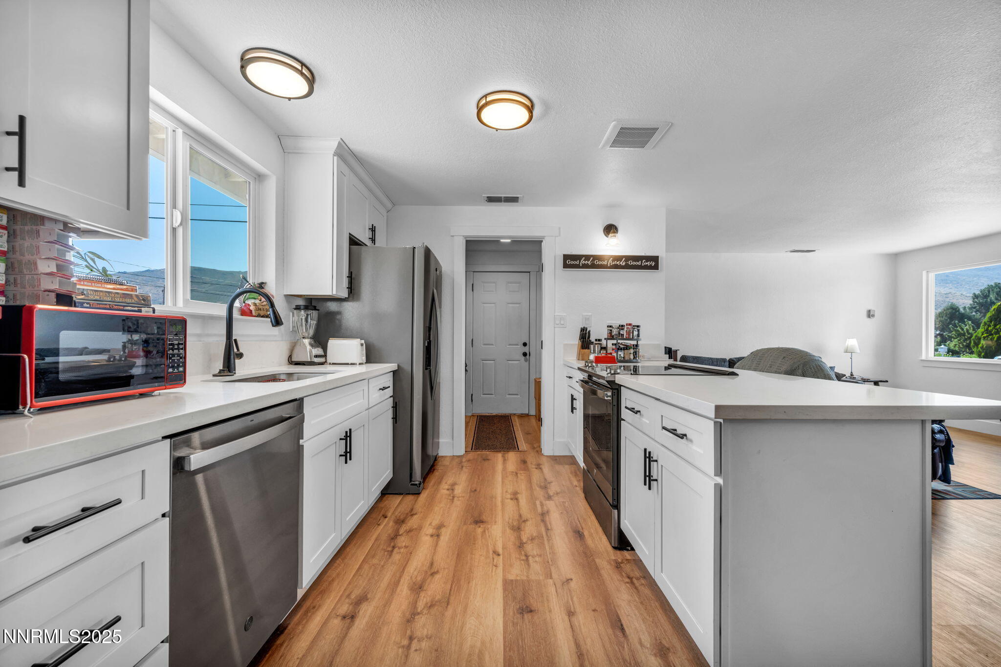 17265 Cold Springs Drive Reno, NV 89508 - Photo 8 of 52 a kitchen with white cabinets and stainless steel appliances