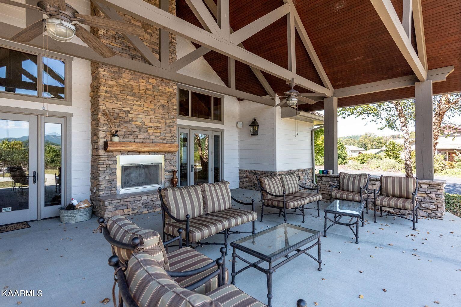 326 Shooting Star Loop, Unit 102 Townsend, TN 37882 - Photo 20 of 22 a outdoor living space with patio furniture and a fireplace