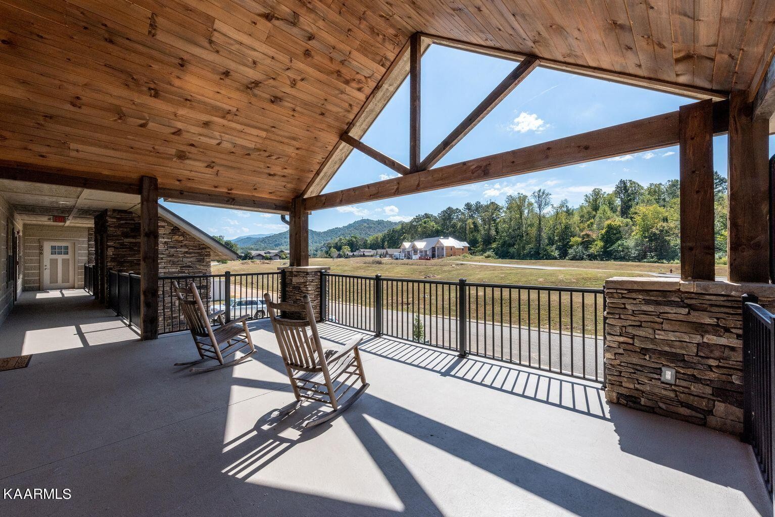 326 Shooting Star Loop, Unit 102 Townsend, TN 37882 - Photo 22 of 22 a view of a patio with table and chairs and wooden floor