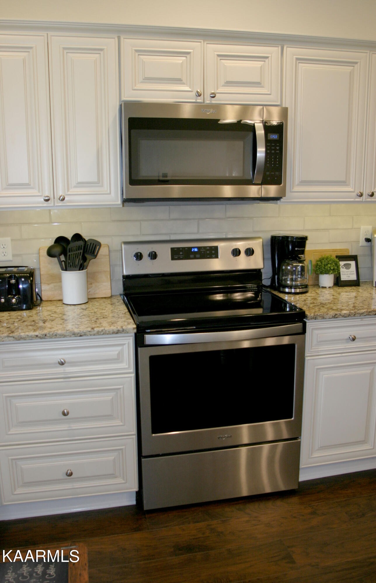 326 Shooting Star Loop, Unit 102 Townsend, TN 37882 - Photo 8 of 22 a kitchen with granite countertop a stove and a microwave