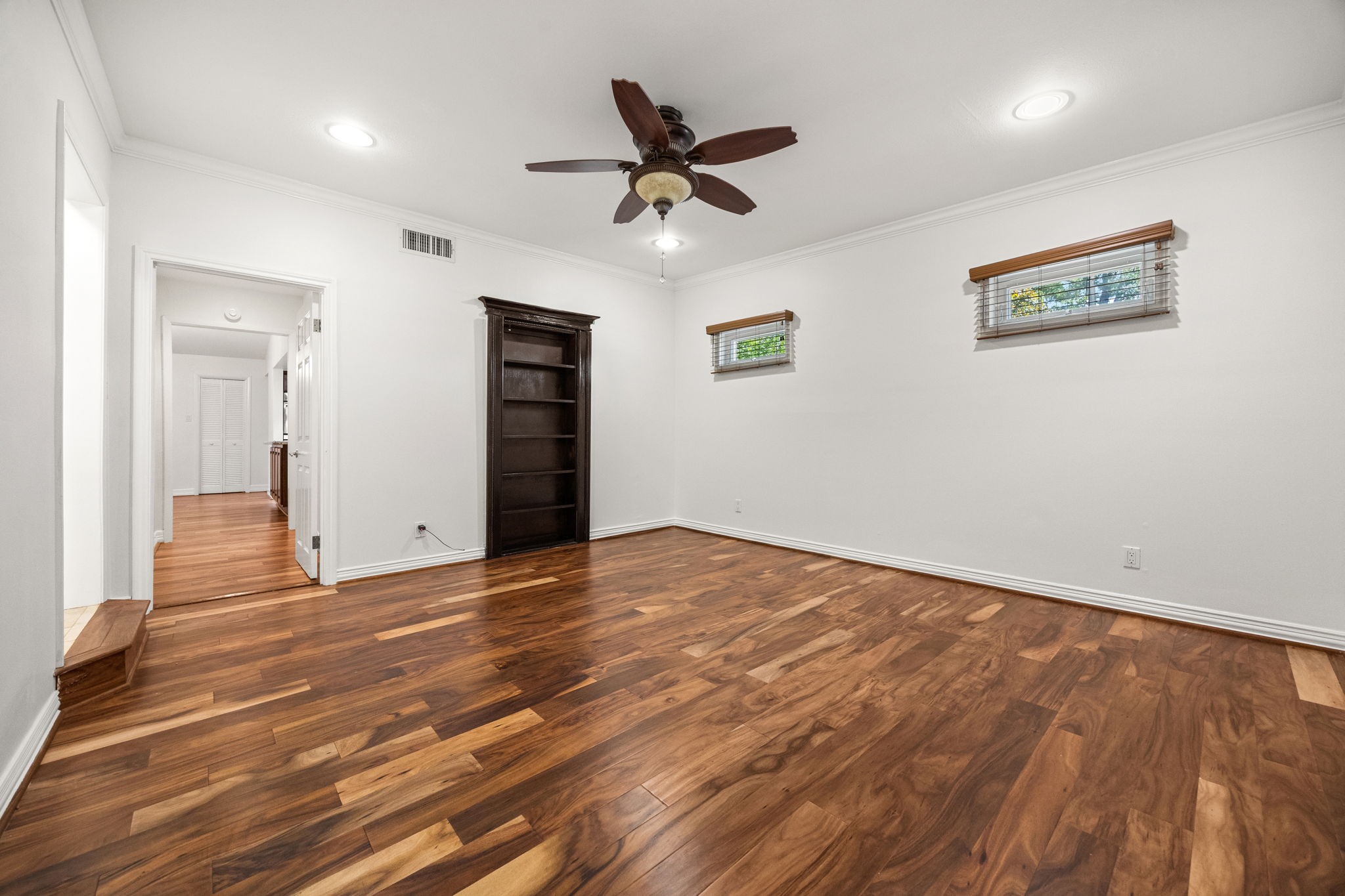 10310 Mayfield Road Houston, TX 77043 - Photo 26 of 49 Large primary bedroom has wood floors and ensuite bath, plus 2 walk-in closets
