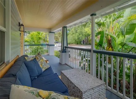 a balcony with furniture and a large window
