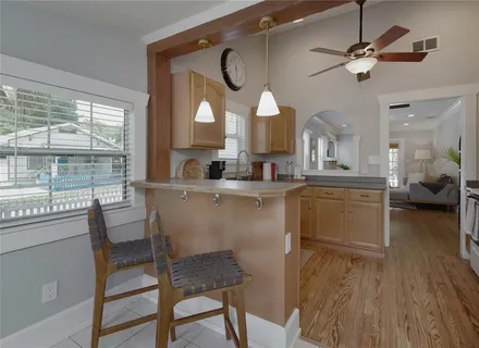 a kitchen with a table chairs appliances and cabinets