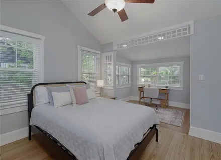 a bedroom with a large bed and a window