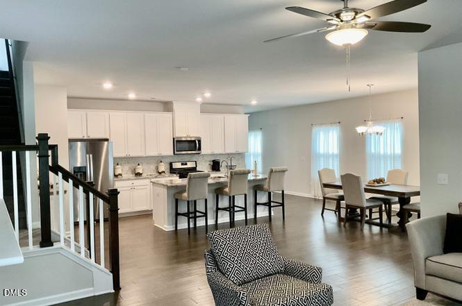 1807 Wrenn Road Durham, NC 27703 - Photo 11 of 43 a view of a dining room with furniture wooden floor and chandelier