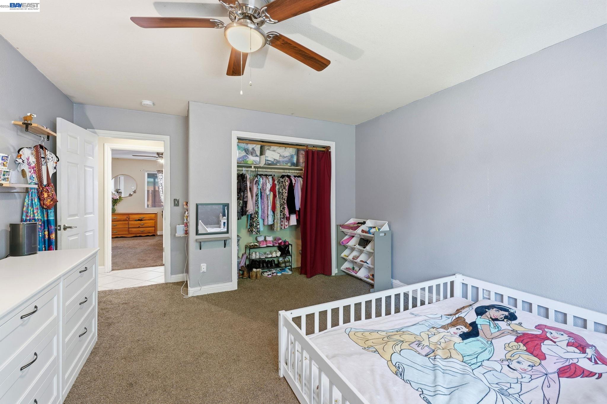 10378 South Priest Road French Camp, CA 95231 - Photo 25 of 44 a bedroom with furniture and a chandelier