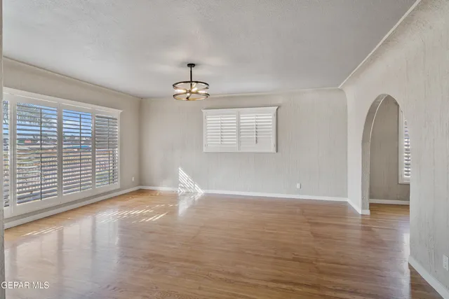 a utility room with wooden floor washer and dryer