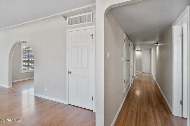 a view of a hallway with wooden floor