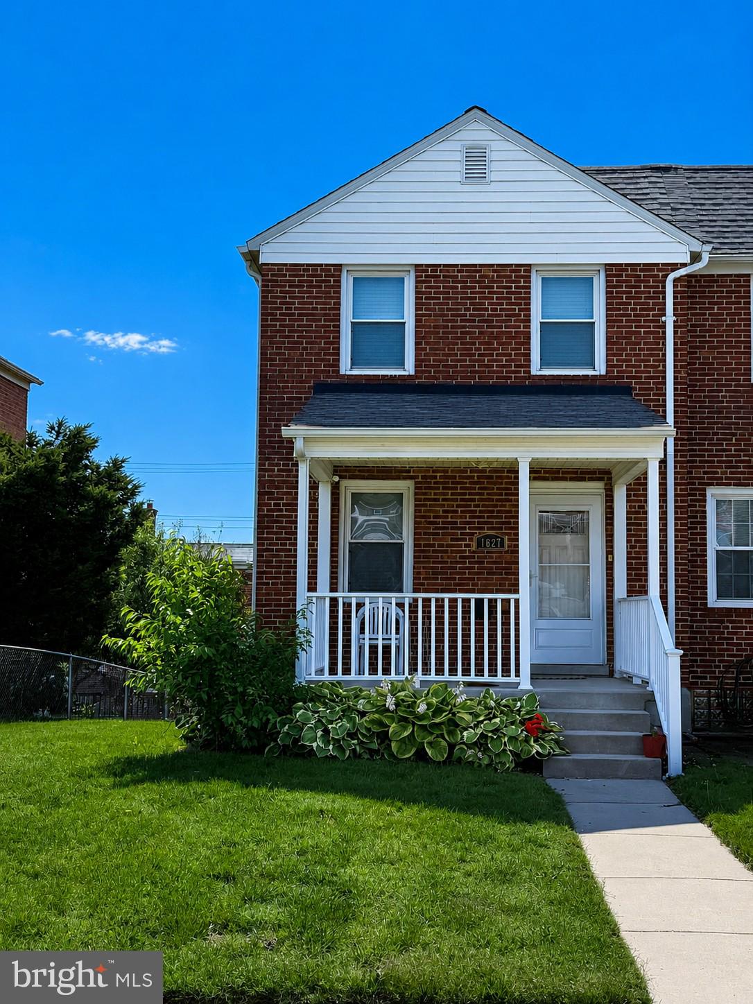 1627 Manor Road Baltimore, MD 21222 - Photo 1 of 2 Charming brick home with lush greenery.