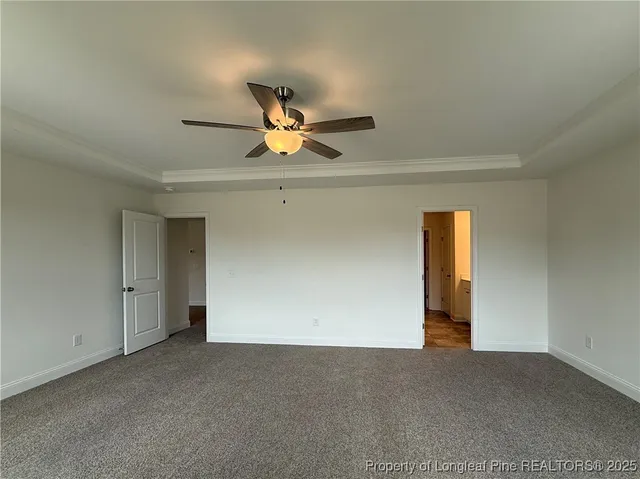 a view of a livingroom with a ceiling fan and window