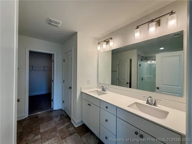 a bathroom with double sink and a mirror