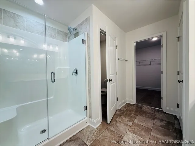 a bathroom with a shower and a sink