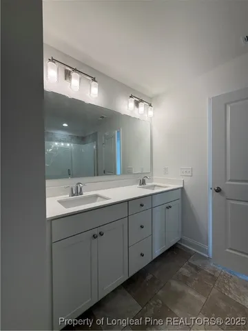 a bathroom with a double vanity sink and mirror