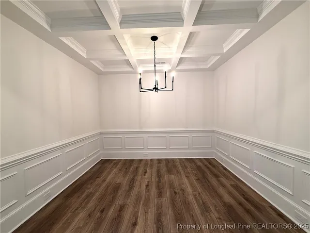 a view of a room with wooden floor and window