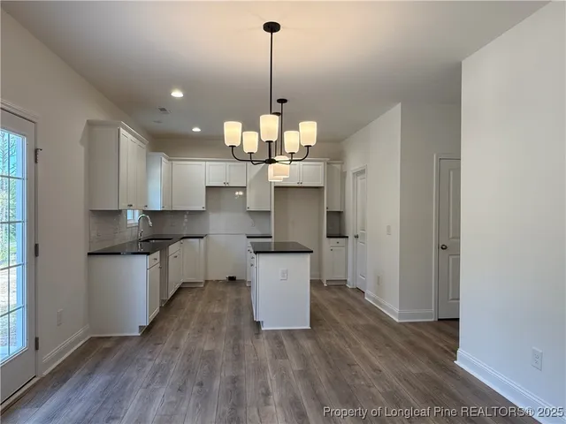 a kitchen with a refrigerator and cabinets