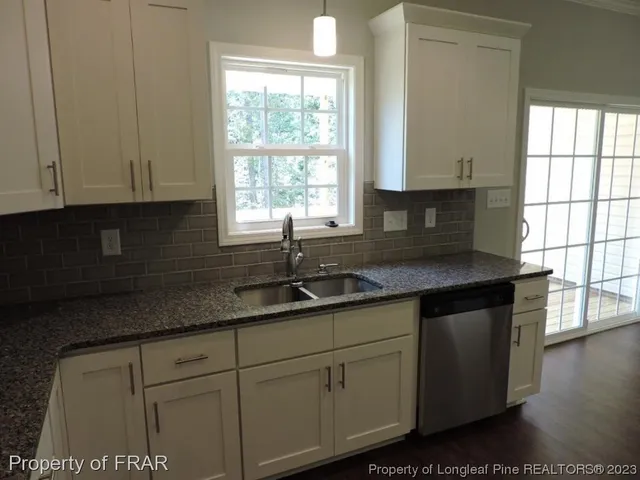 a kitchen with cabinets and window