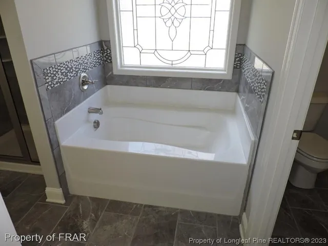 a bath tub sitting next to a window