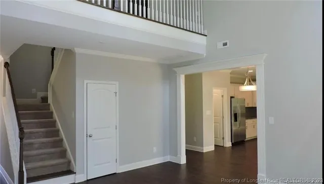 a view of a hallway with wooden floor and entryway