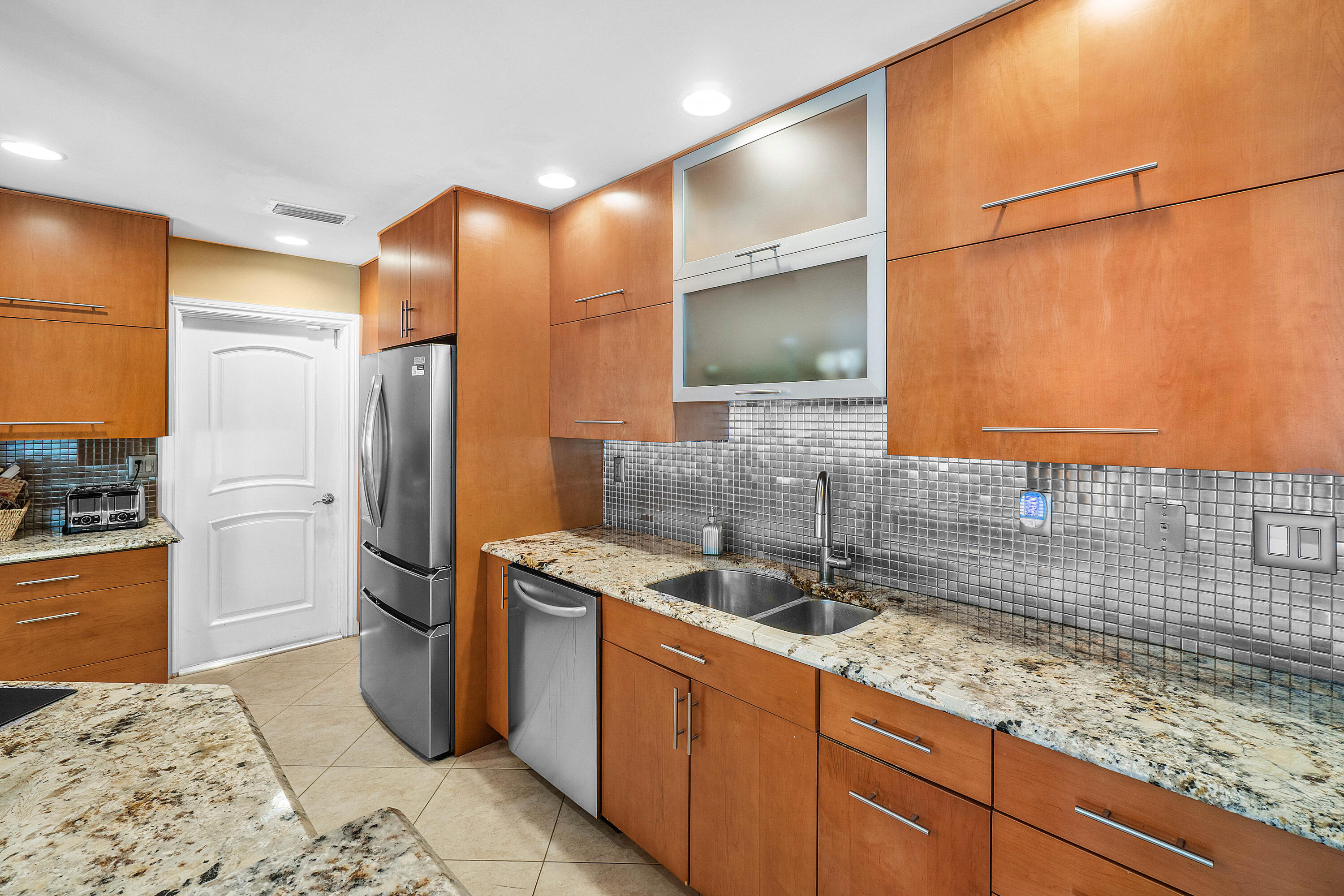 3509 Northwest 26th Court Boca Raton, FL 33434 - Photo 12 of 33 a kitchen with stainless steel appliances granite countertop a sink stove and refrigerator
