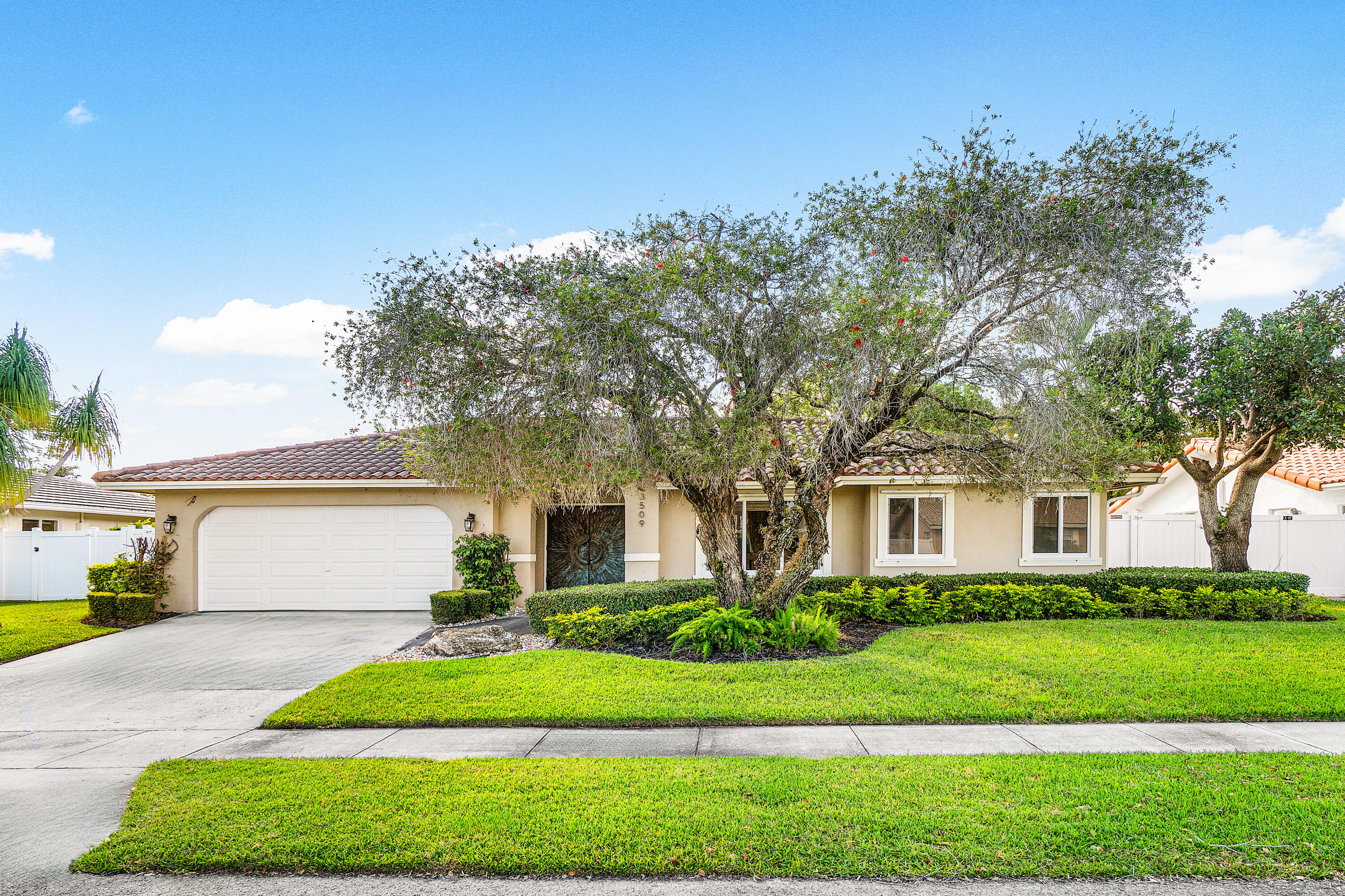 3509 Northwest 26th Court Boca Raton, FL 33434 - Photo 13 of 33 a front view of a house with a yard