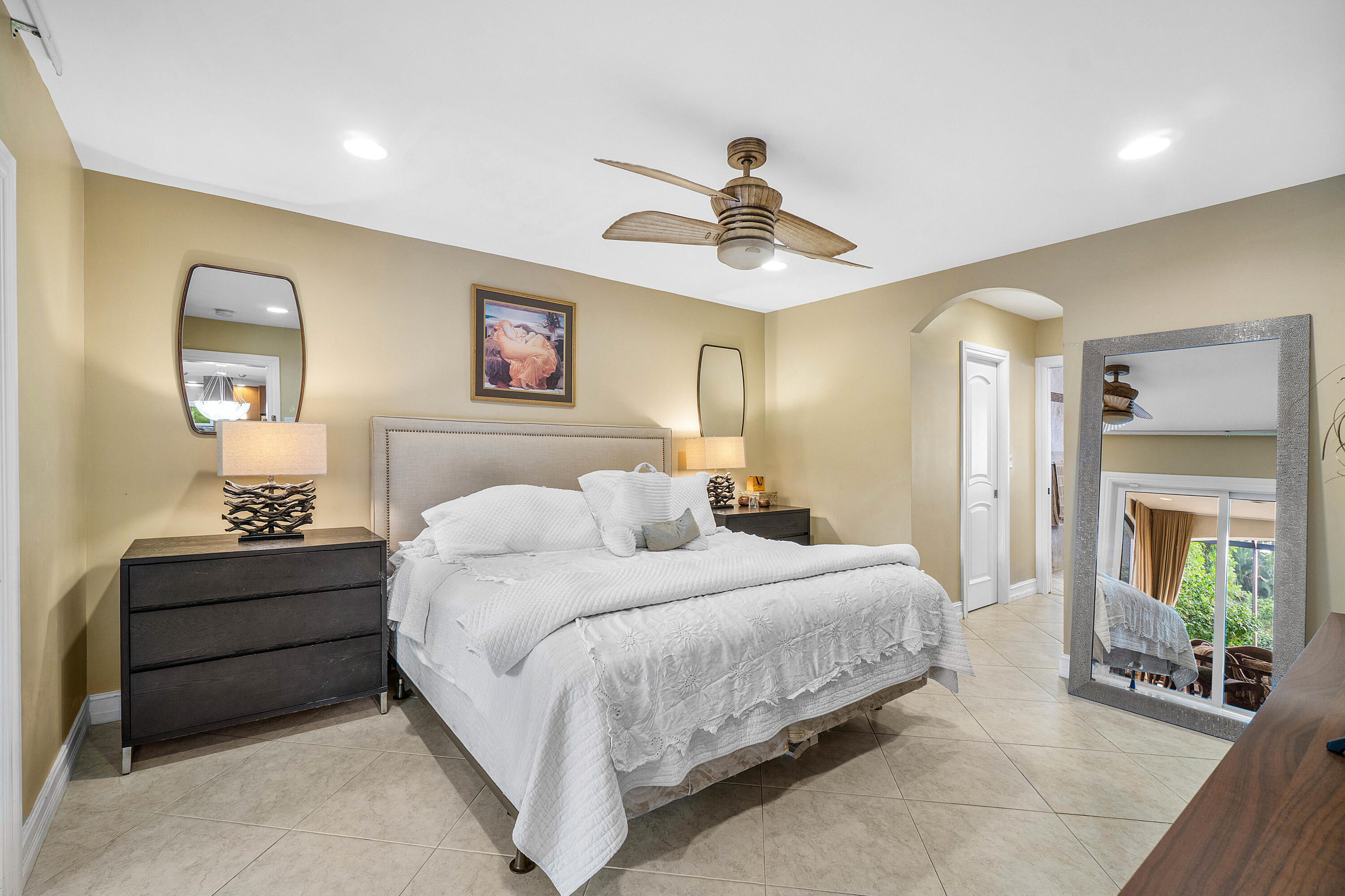 3509 Northwest 26th Court Boca Raton, FL 33434 - Photo 18 of 33 a bedroom with bed and a chandelier