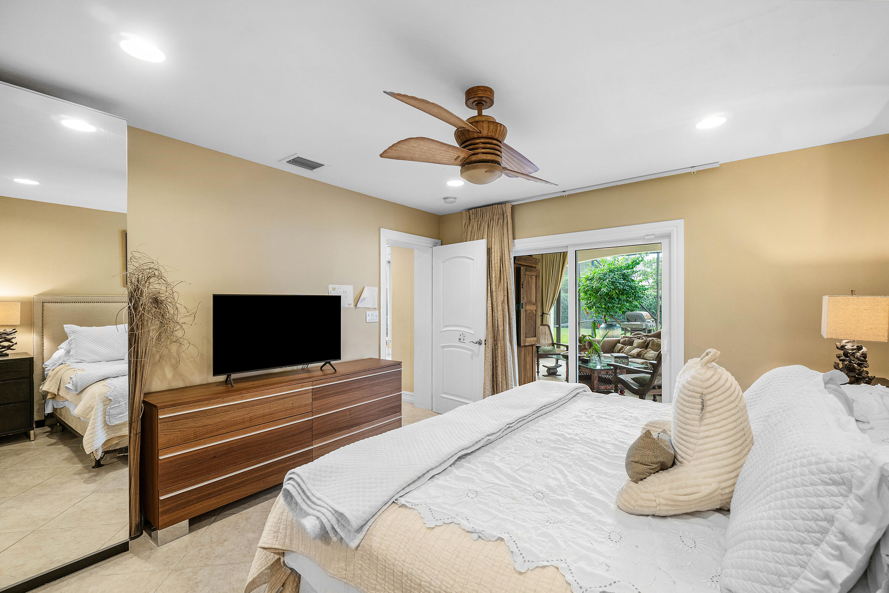 3509 Northwest 26th Court Boca Raton, FL 33434 - Photo 19 of 33 a bedroom with a bed and a flat screen tv