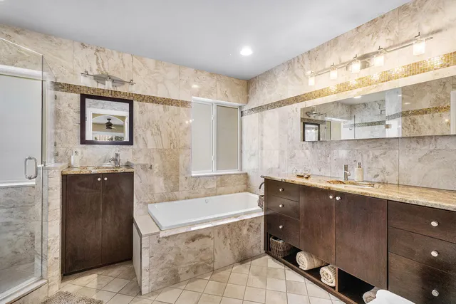 a spacious bathroom with a sink mirror and a bathtub