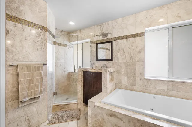 a bathroom with a bathtub and a shower