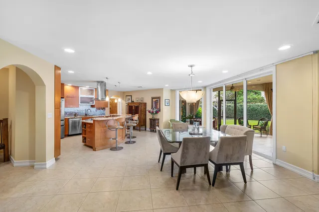 a dining room with furniture and a view of kitchen
