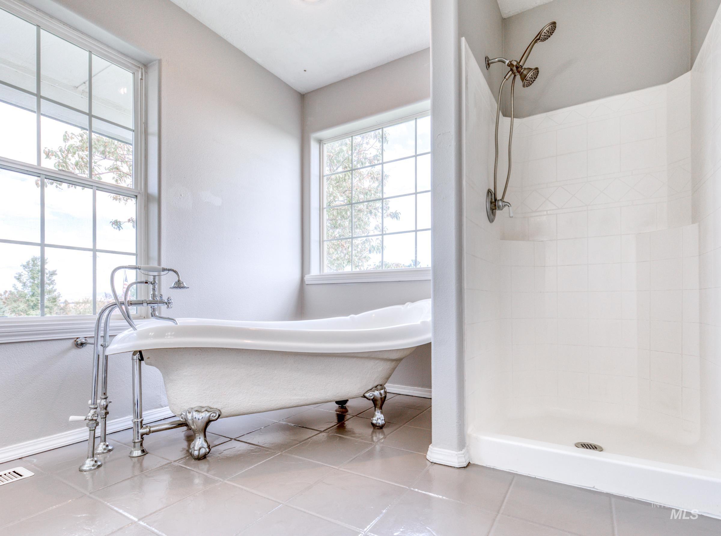 16277 Sand Hollow Road Caldwell, ID 83607 - Photo 21 of 39 Full bathroom with a stall shower, light tile patterned floors, and a freestanding tub