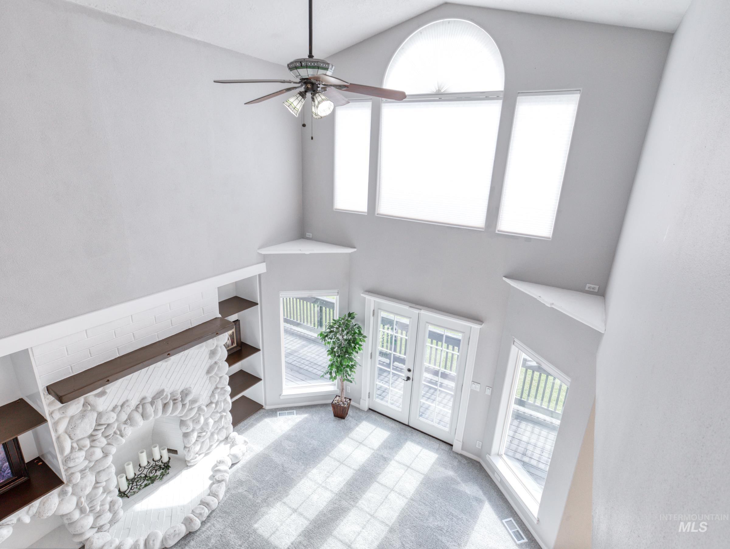 16277 Sand Hollow Road Caldwell, ID 83607 - Photo 28 of 39 Unfurnished living room featuring plenty of natural light, carpet flooring, french doors, high vaulted ceiling, and a ceiling fan