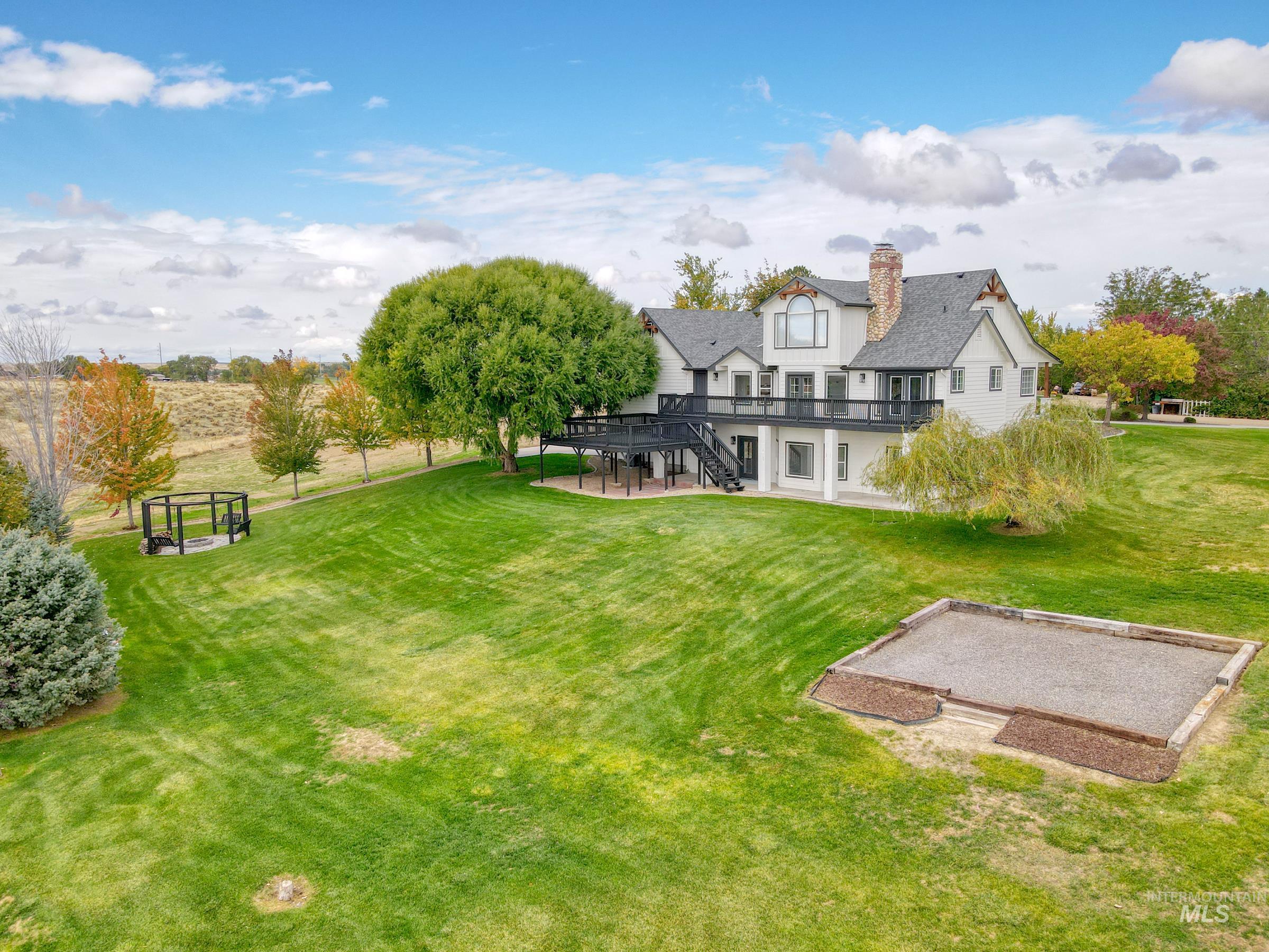 16277 Sand Hollow Road Caldwell, ID 83607 - Photo 36 of 39 View of grassy yard featuring a patio, stairs, a garden, and a wooden deck