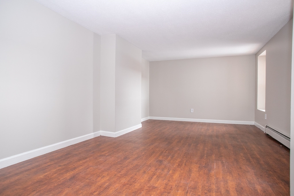 35 Cedar Street, Unit 2 Gardner, MA 01440 - Photo 13 of 32 a view of an empty room with wooden floor