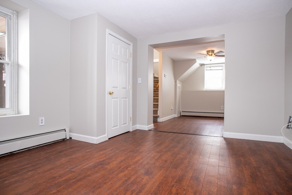 35 Cedar Street, Unit 2 Gardner, MA 01440 - Photo 16 of 32 an empty room with wooden floor and windows