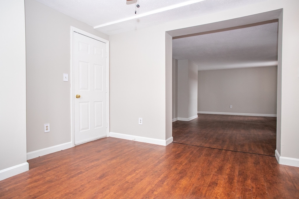 35 Cedar Street, Unit 2 Gardner, MA 01440 - Photo 17 of 32 an empty room with wooden floor & closet area