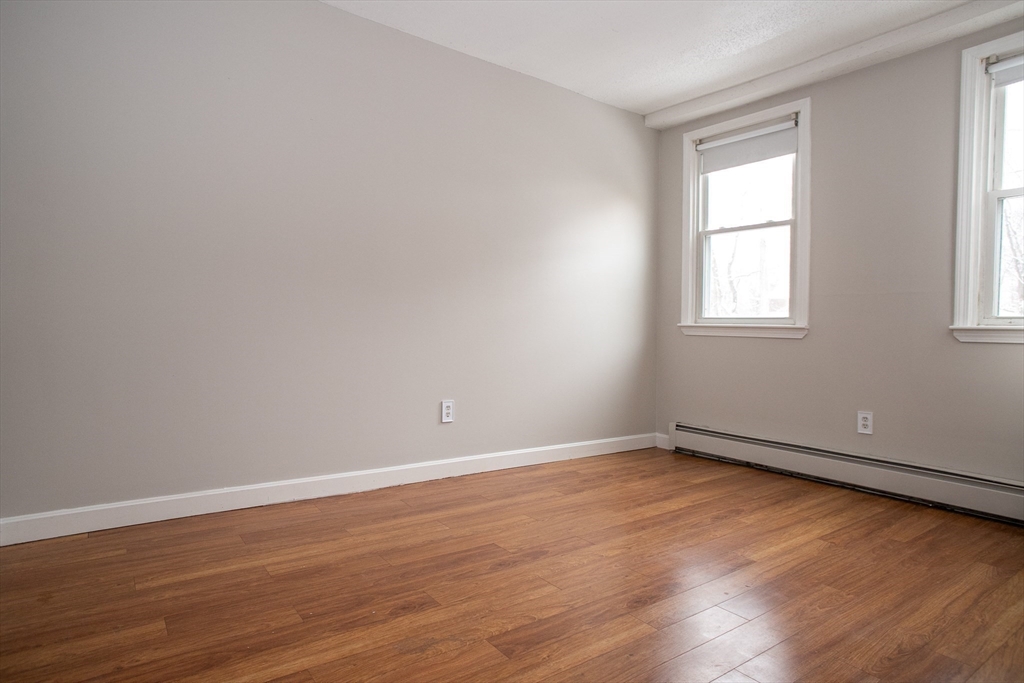35 Cedar Street, Unit 2 Gardner, MA 01440 - Photo 22 of 32 a view of an empty room with wooden floor and a window