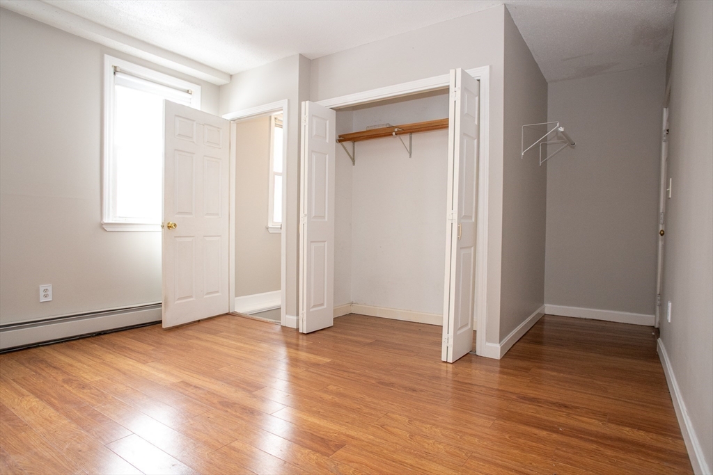 35 Cedar Street, Unit 2 Gardner, MA 01440 - Photo 23 of 32 an empty room with wooden floor and entrance