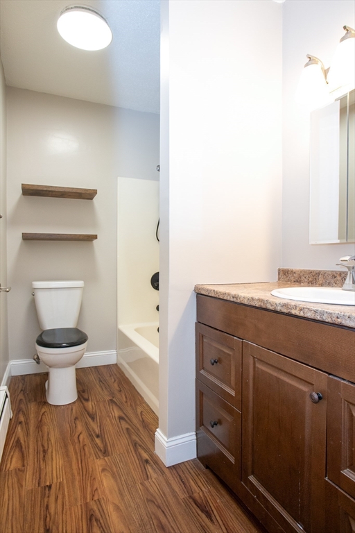 35 Cedar Street, Unit 2 Gardner, MA 01440 - Photo 25 of 32 a spacious bathroom with a toilet sink and mirror