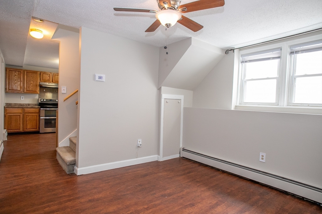 35 Cedar Street, Unit 2 Gardner, MA 01440 - Photo 9 of 32 wooden floor in an empty room with a window