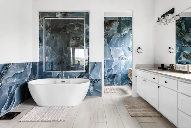 a spacious bathroom with a double vanity sink a mirror and a bathtub