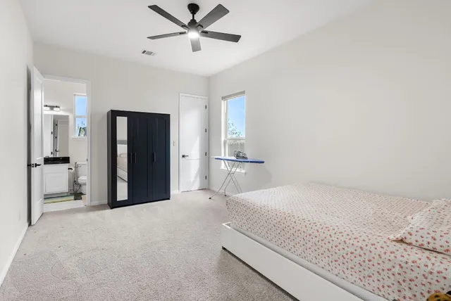 a bathroom with a toilet a sink and a window