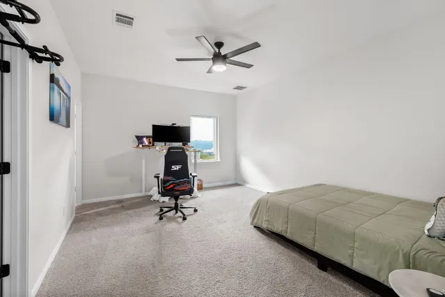 a bedroom with bed and a chandelier