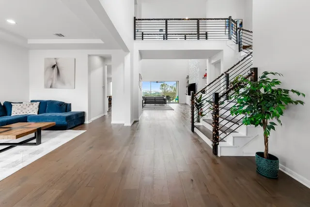 a living room with furniture and a potted plant