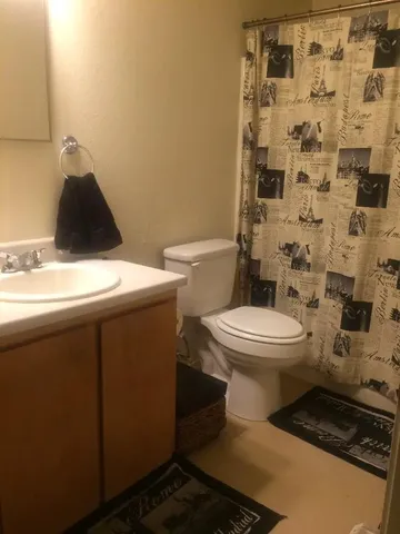 a bathroom with a toilet and a shower