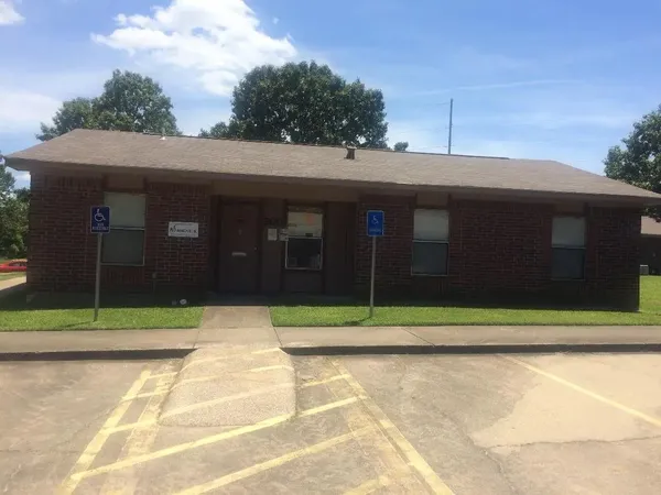 a view of a brick house with a large space