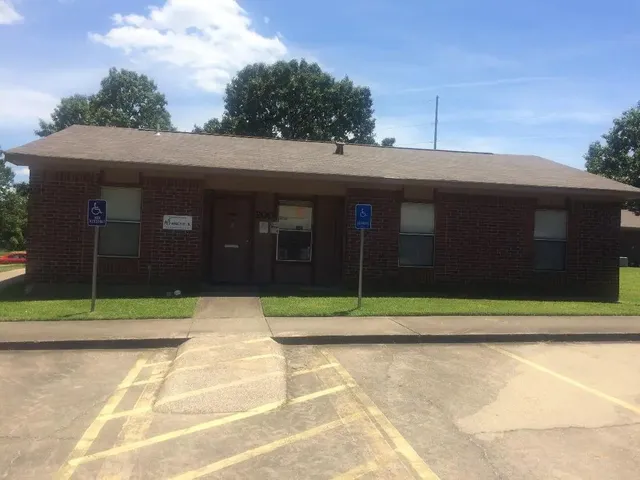 a view of a brick house with a large space