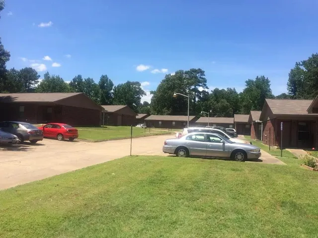 a view of a white house with a yard and tv