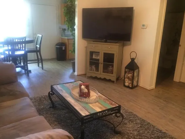 a living room with furniture and a flat screen tv