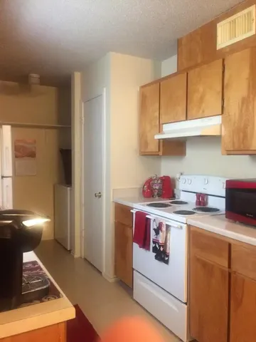 a kitchen with stainless steel appliances granite countertop a stove and a refrigerator