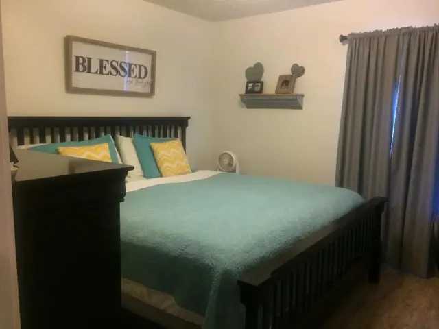 a bed sitting in a bedroom next to a cabinet